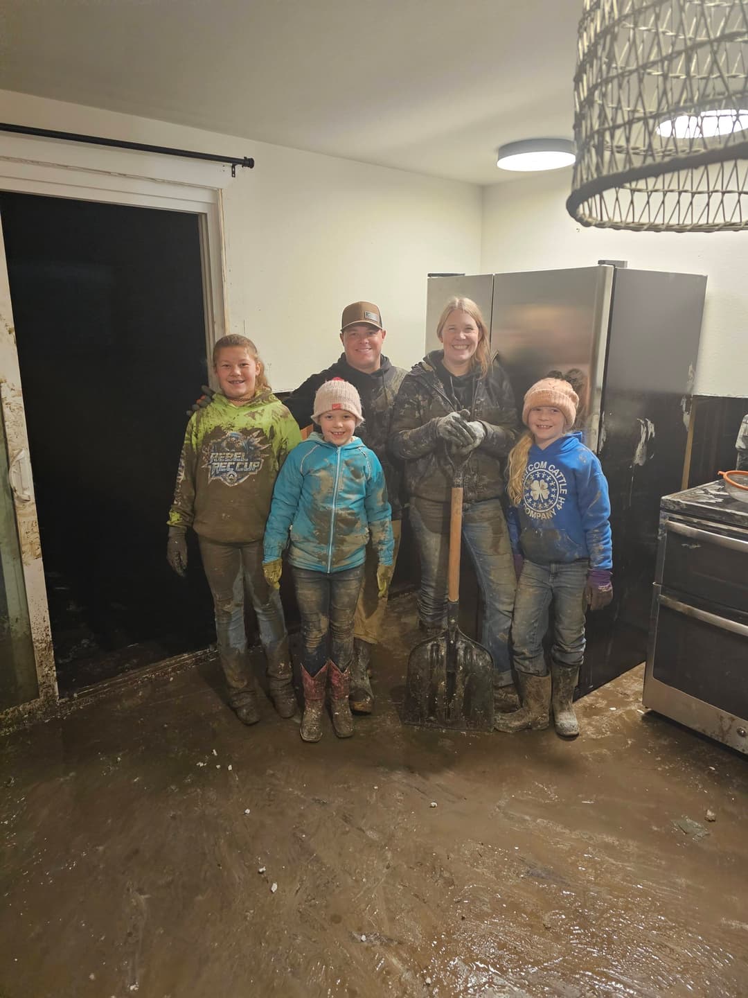 TC BUILDS family doing flood cleanup